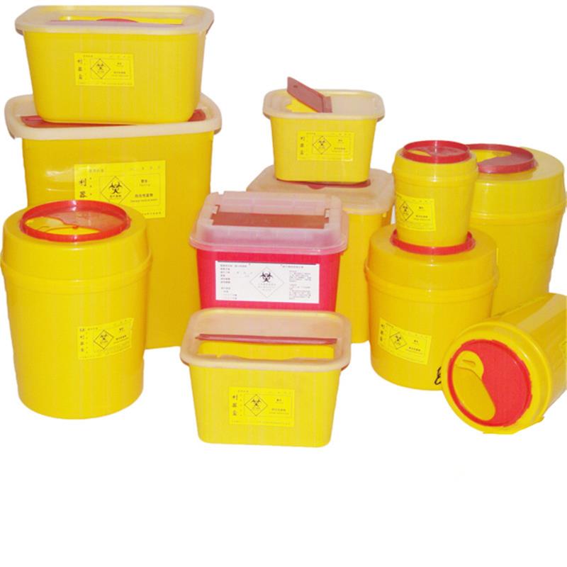 Many yellow round and square sharps boxes are placed together