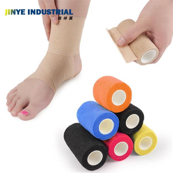 A bandage is wrapped around the foot, and there are neat piles of adhesive bandages next to it