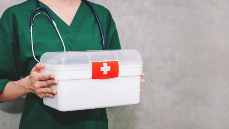 nurse holding first aid kit