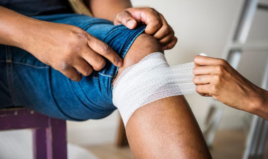 Nurse bandaging patient with gauze