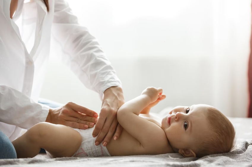 mother changing baby's diaper