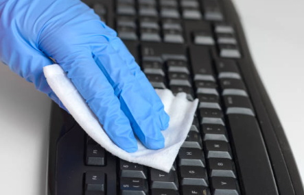 Wipe the keyboard with alcohol wipes while wearing nitrile gloves