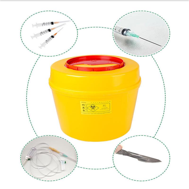 Next to a round sharps box are syringes, infusion sets and other medical waste